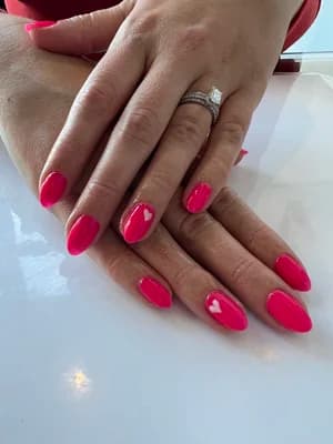 Rounded almond nails in bright glossy magenta-pink solid color, silver ring visible.