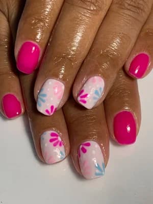 Hot pink solid nails with white accents featuring hand-painted pink and blue floral petals.