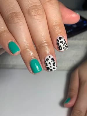 Solid teal green nails with black and white leopard print accent nail.