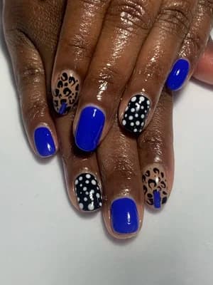 Cobalt blue nails mixed with black and white leopard print and polka dots.