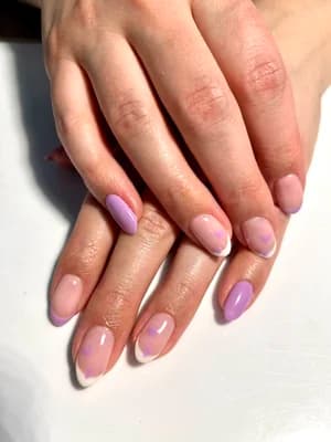 Lilac purple nails with white French tips and soft pink ombre gradient, rounded almond shape.