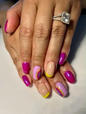 Magenta glitter nails with nude accents, purple-yellow sunburst design and yellow tips.