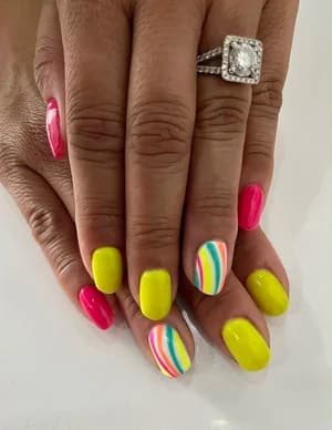 Neon yellow and hot pink nails with pastel rainbow stripe accent nails.