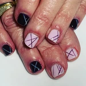 Navy and pale pink nails with thin black geometric crosshatch and triangle line work