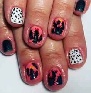 Coral and dark teal nails with desert cactus sunset scenes and triangle patterns