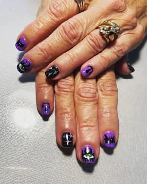 Chrome purple and black nails with Halloween bat and spider art, high-shine metallic finish