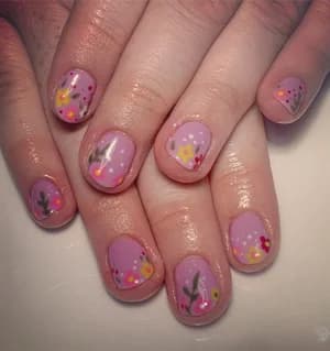 Sheer lilac nails with delicate yellow and purple wildflower line art and scattered dots