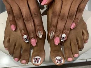 Pink fingernails and toenails with butterfly decals and silver glitter accent nails