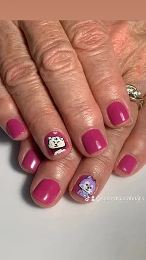 Short magenta pink nails with two cartoon accents, a white dog and purple character face