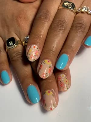 Solid light blue nails paired with sheer nails scattered with tiny multicolor ditsy flowers