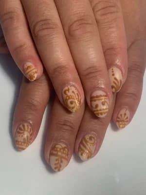 Almond nude nails with golden-brown henna-style swirl and mandala line work