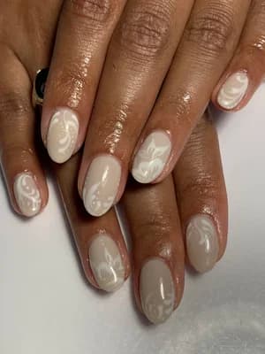 Almond milky nude nails with raised white 3D swirl floral relief design