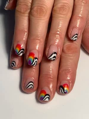 Nude nails with rainbow-striped waves and black-and-white swirled abstract line work