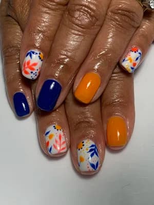 Cobalt blue and orange solids paired with white nails showing hand-painted foliage in matching tones