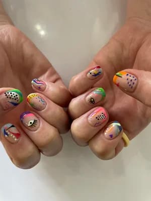 Colorful abstract mix-and-match nails with polka dots, eyes, rainbows and painterly brushstrokes