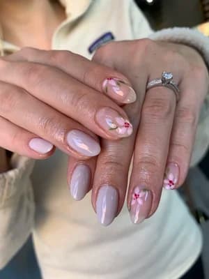 Milky nude almond nails with glossy finish and small red-pink hand-painted cherry blossoms.