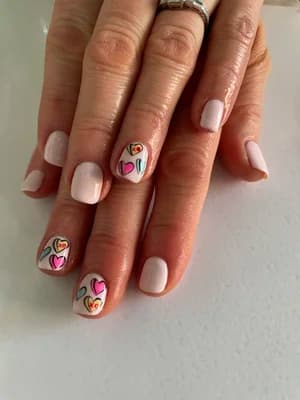 Pale pink and white nails with colorful outlined heart line art in pink, orange, yellow